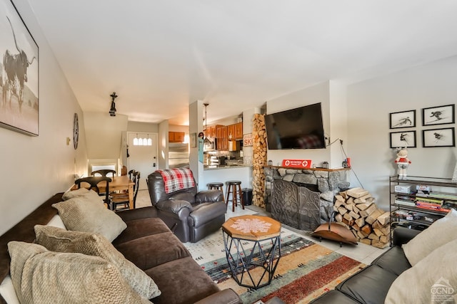 living room with a stone fireplace