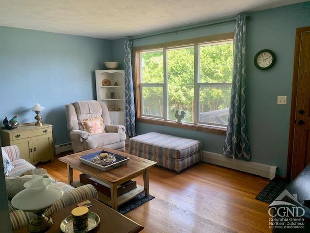 sitting room featuring light wood-type flooring and a baseboard radiator