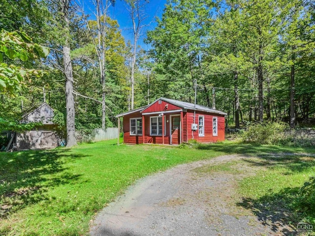 view of outbuilding featuring a lawn