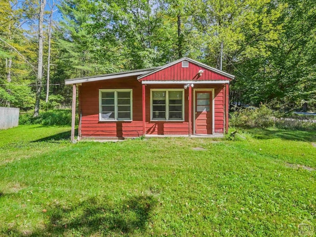 view of outbuilding featuring a yard