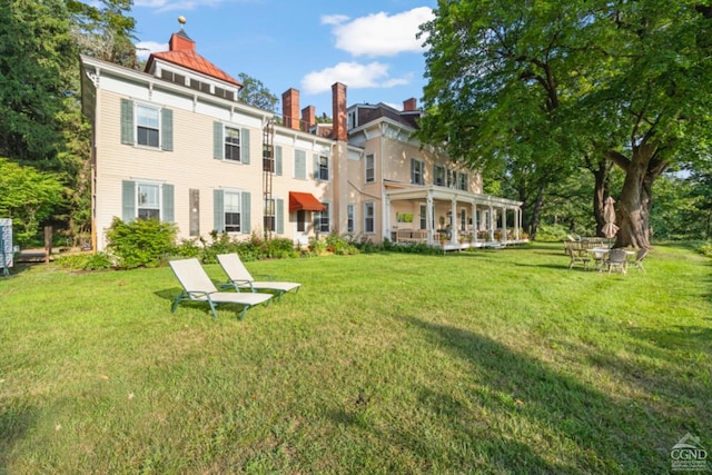 rear view of house with a lawn