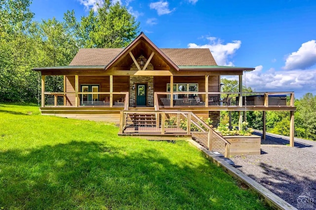 back of house with a lawn and covered porch