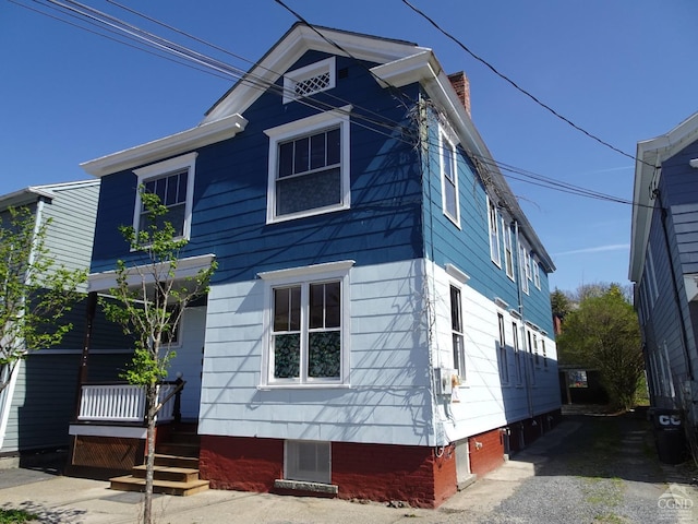 view of front facade with a chimney