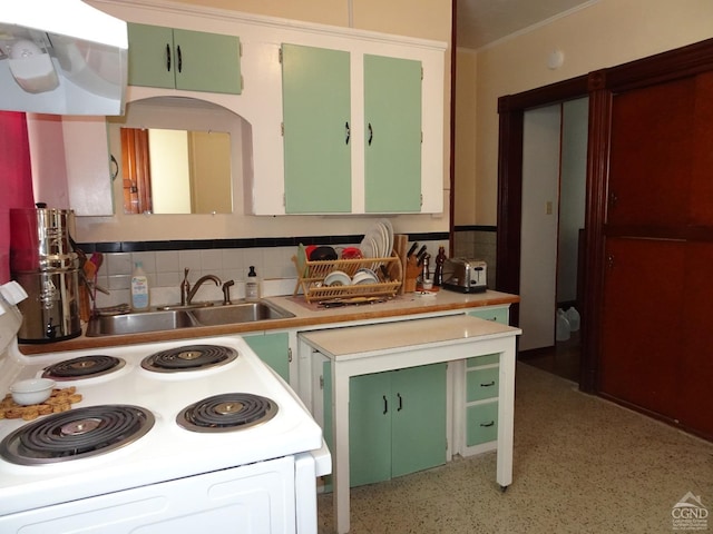 kitchen featuring tasteful backsplash, electric range, light countertops, and green cabinets