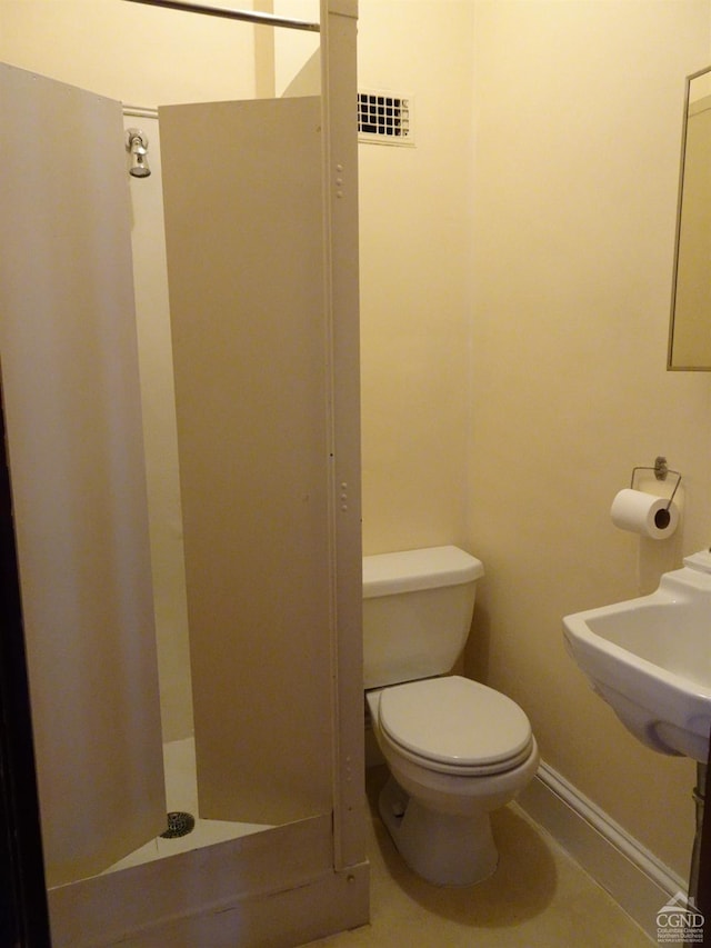 bathroom featuring baseboards, visible vents, and toilet