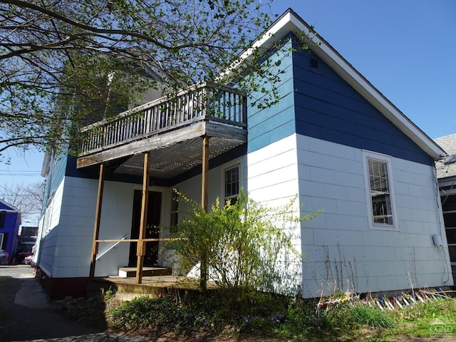 view of side of property with a wooden deck