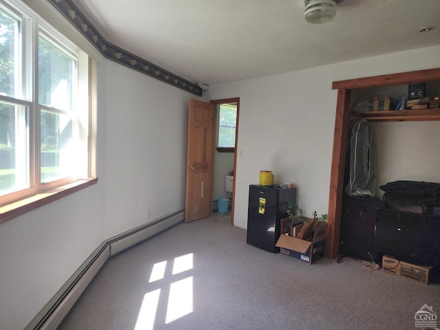 carpeted bedroom with baseboard heating