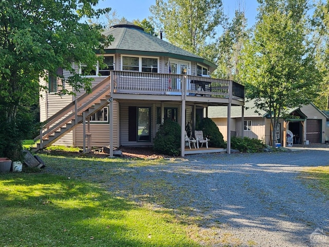 view of front of house with a shed and a deck