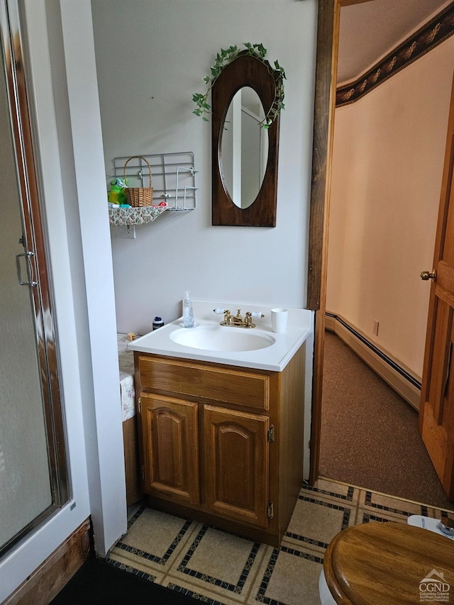 bathroom featuring a shower with door, vanity, and a baseboard heating unit