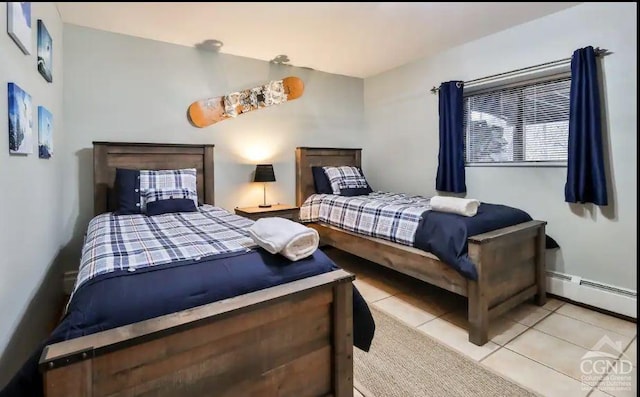 tiled bedroom featuring a baseboard heating unit