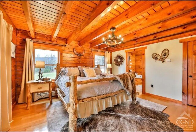 bedroom featuring wood walls, wooden ceiling, beam ceiling, baseboard heating, and light hardwood / wood-style floors