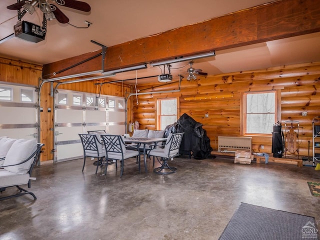 garage with a garage door opener and ceiling fan