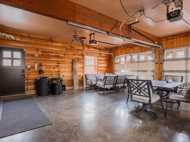 garage with a garage door opener and ceiling fan