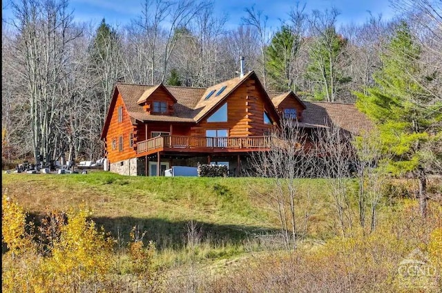 back of property with a wooden deck