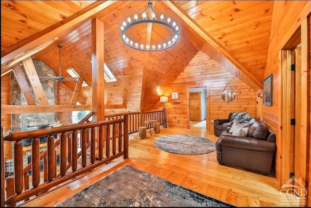 interior space featuring hardwood / wood-style flooring, vaulted ceiling with beams, wood walls, and wooden ceiling