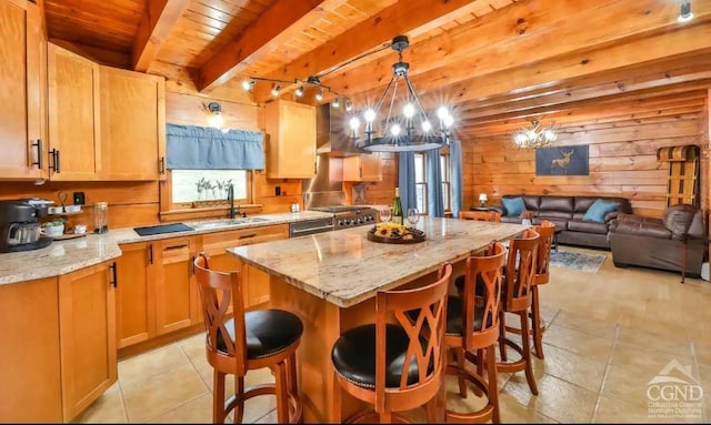 kitchen featuring wood ceiling, sink, an inviting chandelier, beamed ceiling, and a kitchen island