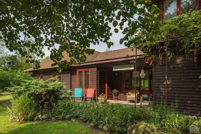 rear view of property featuring a patio