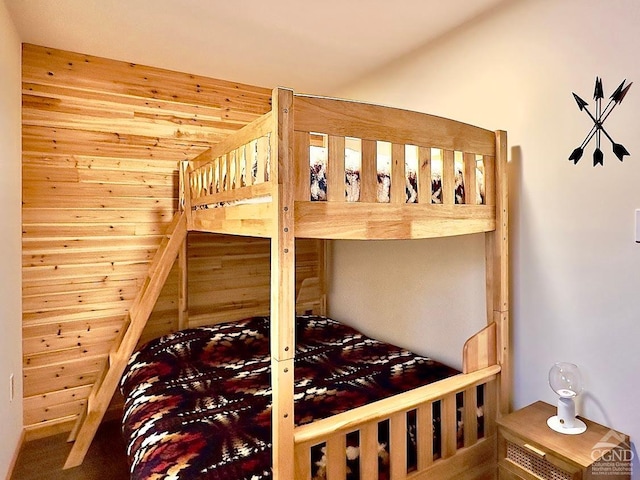 bedroom with wood walls