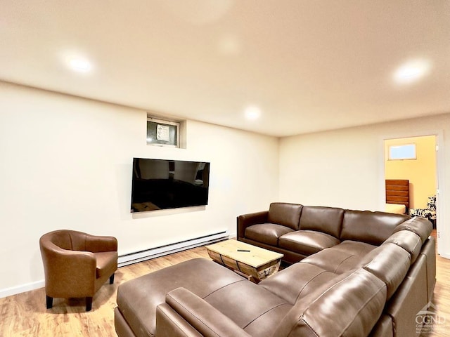 living room featuring light wood-type flooring and baseboard heating