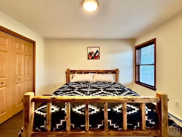 bedroom with a baseboard radiator and a closet