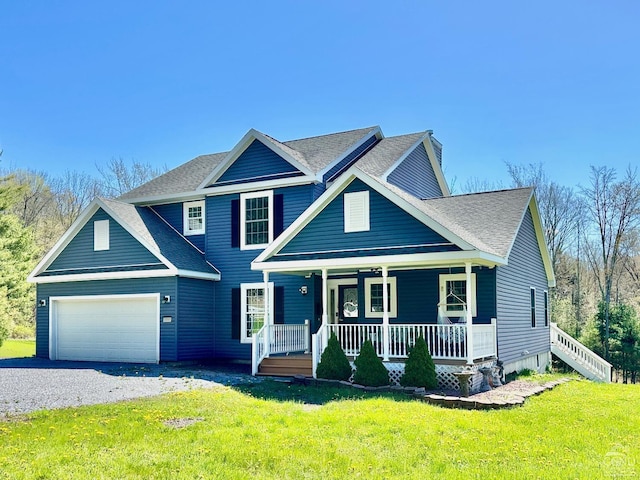 view of front facade featuring a front yard, a porch, and a garage