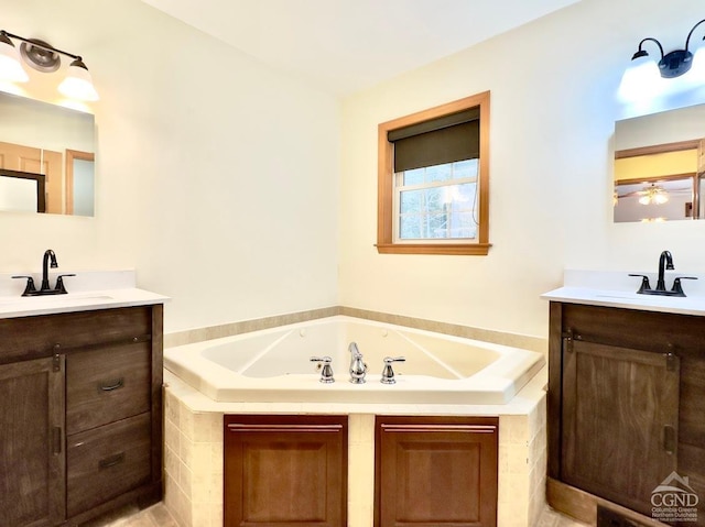 bathroom with a bathtub, vanity, and ceiling fan