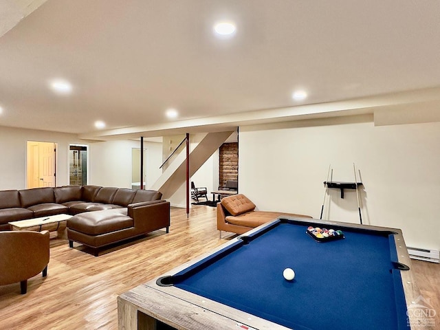 rec room with pool table, a baseboard heating unit, and light wood-type flooring