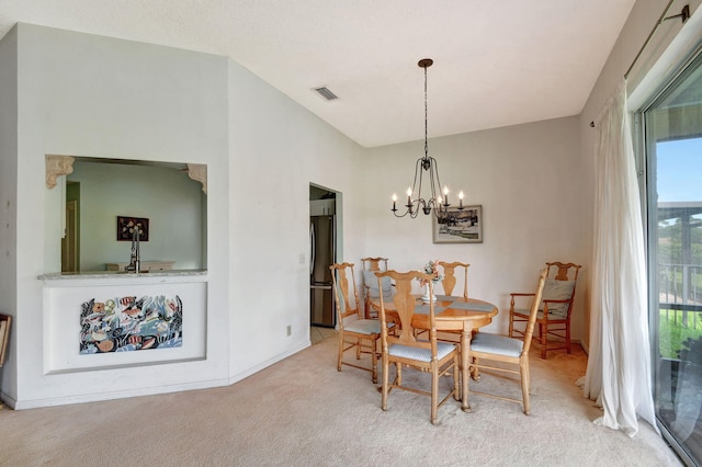 carpeted dining area featuring a chandelier