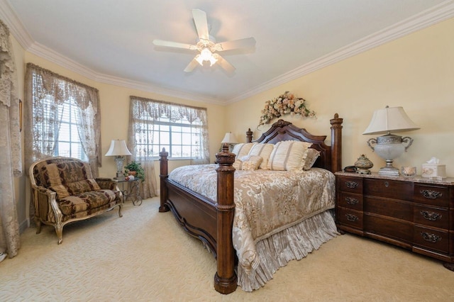 bedroom featuring ornamental molding, light colored carpet, and ceiling fan