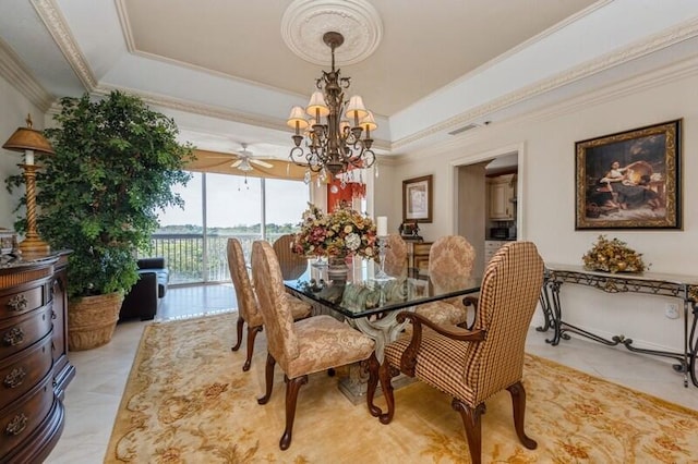 dining room featuring ceiling fan with notable chandelier, a raised ceiling, and crown molding