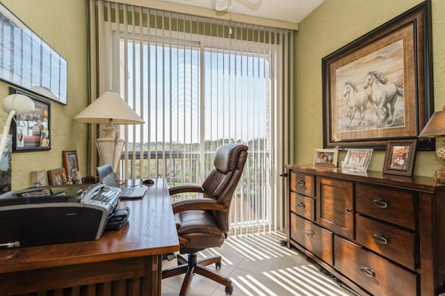 office featuring light tile patterned floors and ceiling fan