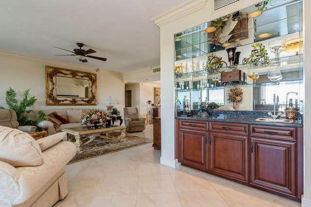 bar featuring ceiling fan, sink, light tile patterned floors, and ornamental molding