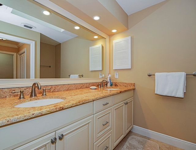 bathroom featuring tile patterned flooring and vanity