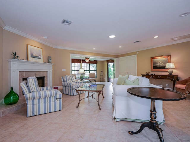 living room featuring ceiling fan, a fireplace, and ornamental molding