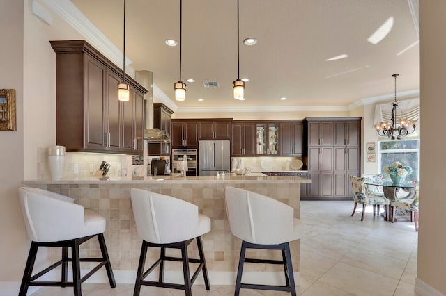 kitchen featuring kitchen peninsula, decorative backsplash, ornamental molding, stainless steel appliances, and hanging light fixtures