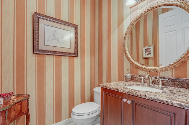 bathroom featuring vanity and toilet