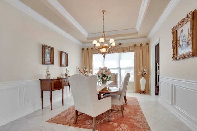 tiled dining space with a tray ceiling, crown molding, and a notable chandelier