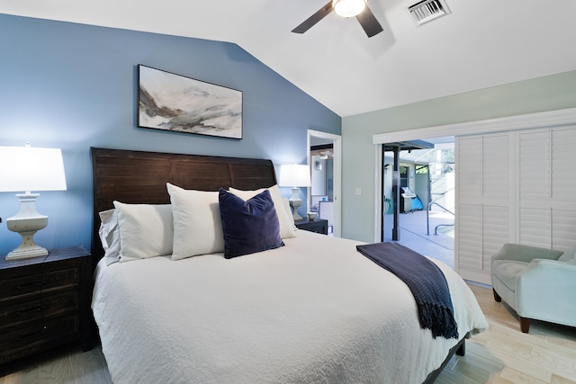 bedroom featuring ceiling fan, light hardwood / wood-style floors, access to exterior, and vaulted ceiling