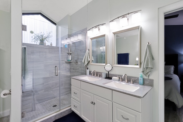 bathroom featuring vanity, an enclosed shower, and lofted ceiling