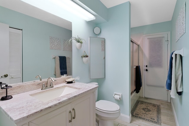 bathroom featuring vanity, toilet, an enclosed shower, and wood-type flooring