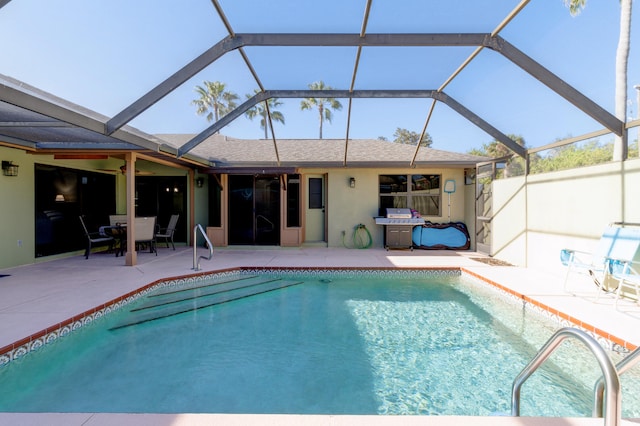 view of swimming pool with a lanai and a patio