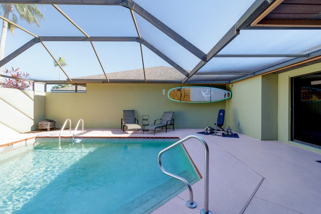 view of pool with a lanai and a patio