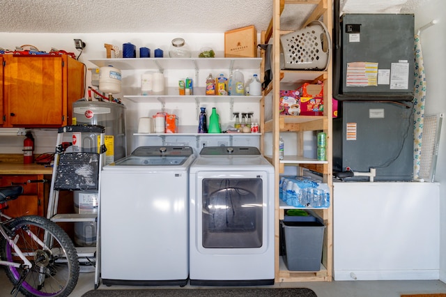 washroom with heating unit, washing machine and dryer, a textured ceiling, and water heater