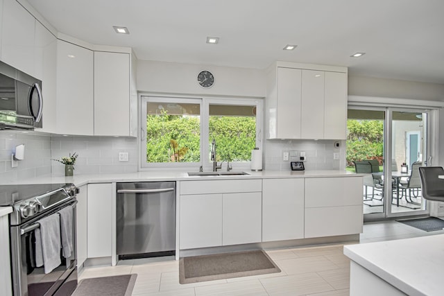 3961 NW 27th Ave, Boca Raton, FL 33434 - kitchen with appliances with stainless steel finishes, modern cabinets, light countertops, and recessed lighting