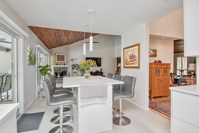 3961 NW 27th Ave, Boca Raton, FL 33434 - dining room featuring a fireplace, wood ceiling, high vaulted ceiling, and light tile patterned flooring