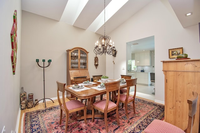 3961 NW 27th Ave, Boca Raton, FL 33434 - dining space featuring a skylight, wood finished floors, a chandelier, and high vaulted ceiling