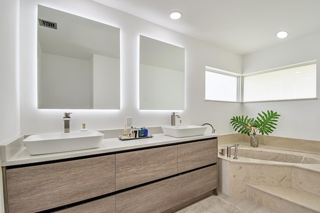 3961 NW 27th Ave, Boca Raton, FL 33434 - full bathroom with double vanity, a garden tub, and recessed lighting