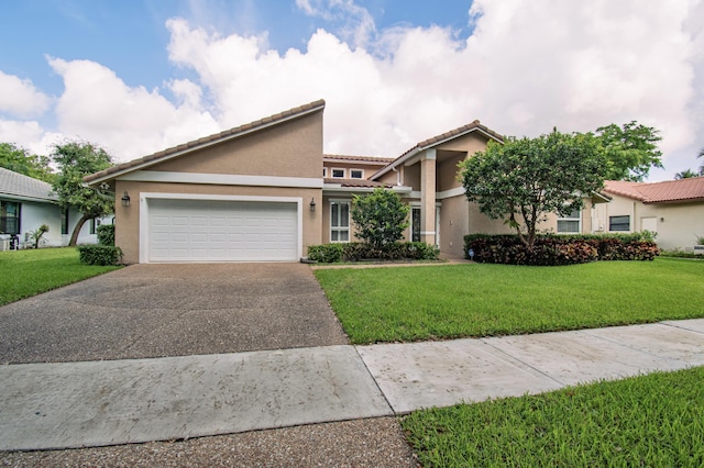 3961 NW 27th Ave, Boca Raton, FL 33434 - view of front of property featuring stucco siding, asphalt driveway, a tile roof, and an attached garage