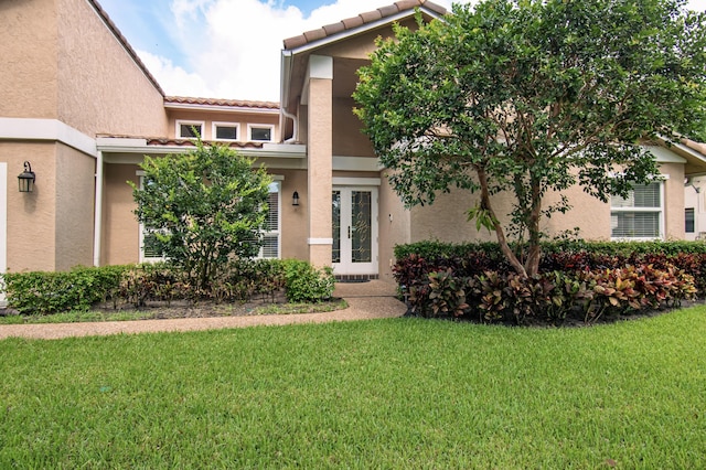 3961 NW 27th Ave, Boca Raton, FL 33434 - view of front of house featuring a front yard, stucco siding, and a tile roof