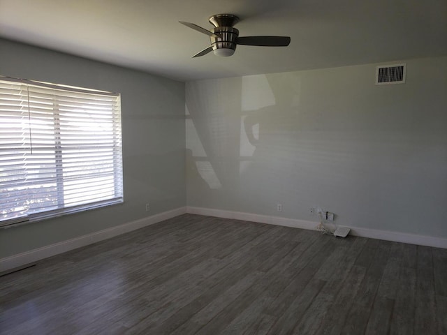 spare room with ceiling fan and dark hardwood / wood-style floors